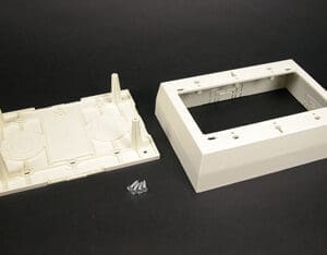 Here's an alt tag for the image: `Off-white plastic wall plate and mounting box`