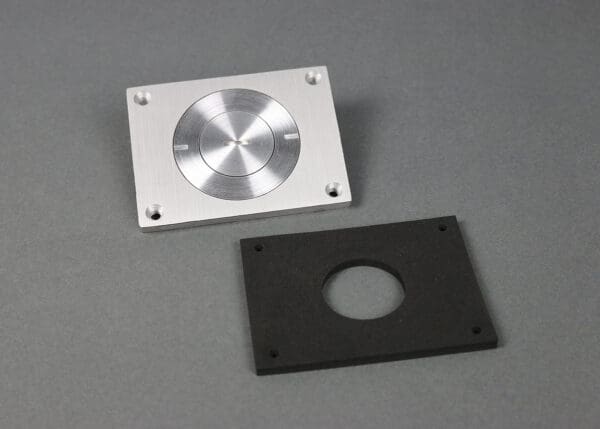 Aluminum plate with circular cutout and gasket.