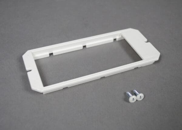 White plastic wall plate with screws.