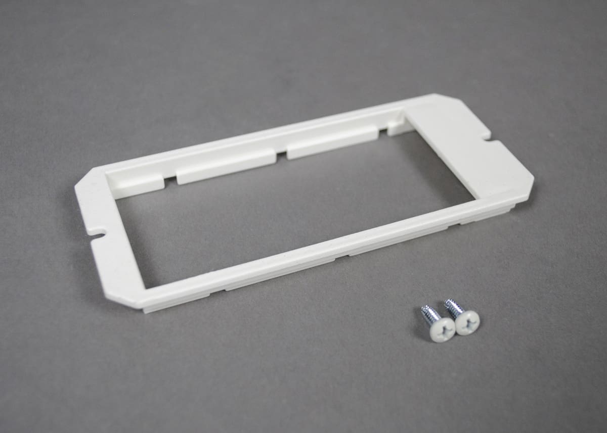 White plastic wall plate with screws.