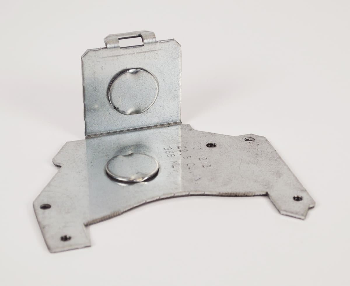 Metal bracket with two magnet recesses.