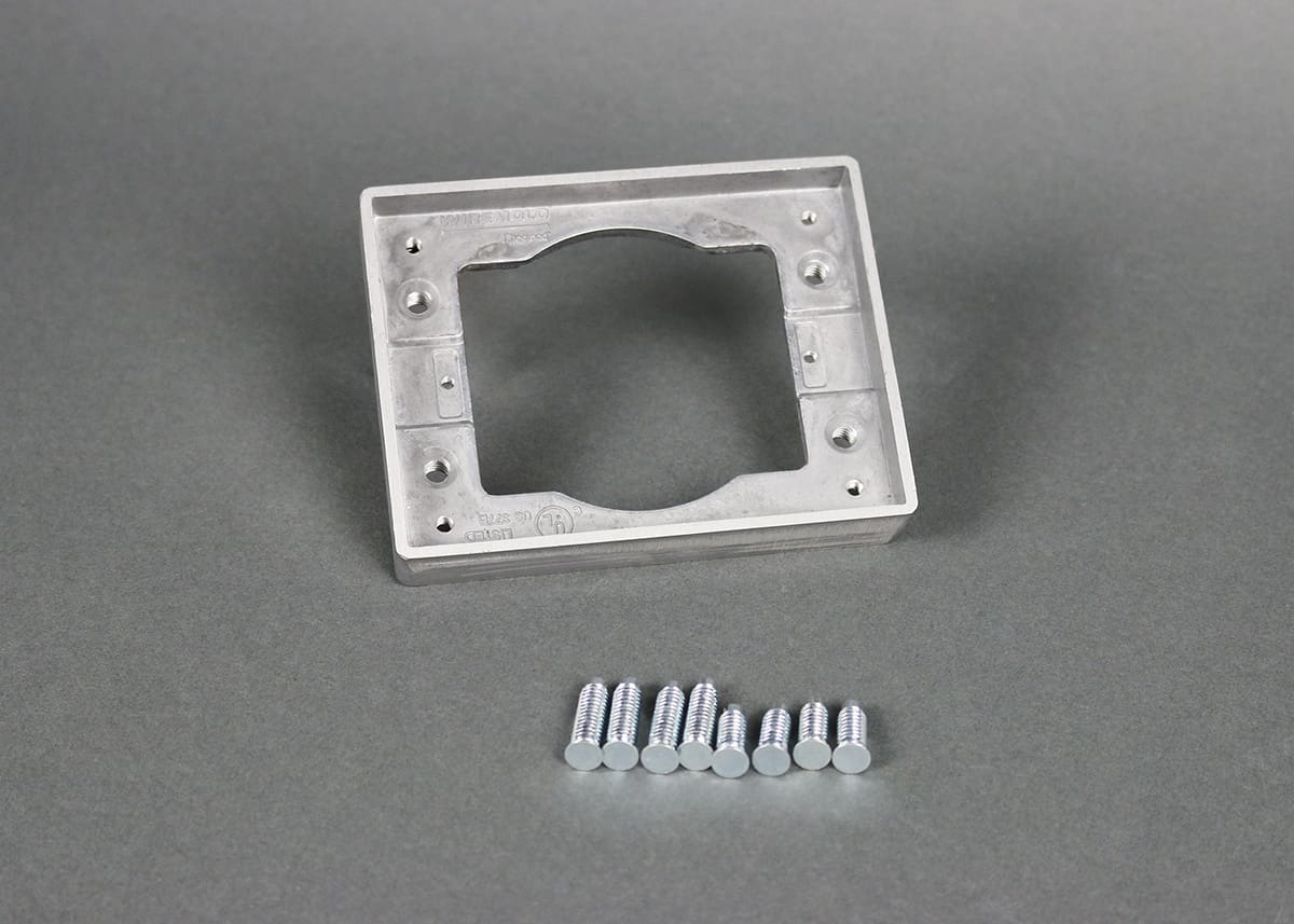 Aluminum electrical box with screws.