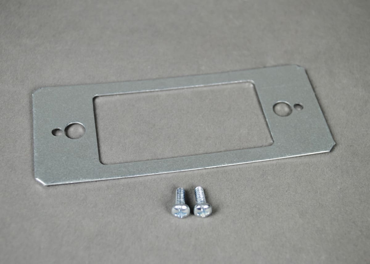 Metal plate with screws for mounting.
