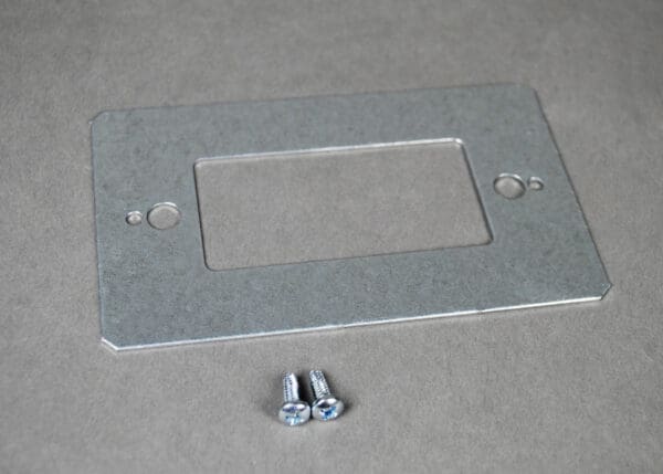 Here's an alt tag for the image: Metal wall plate and screws.