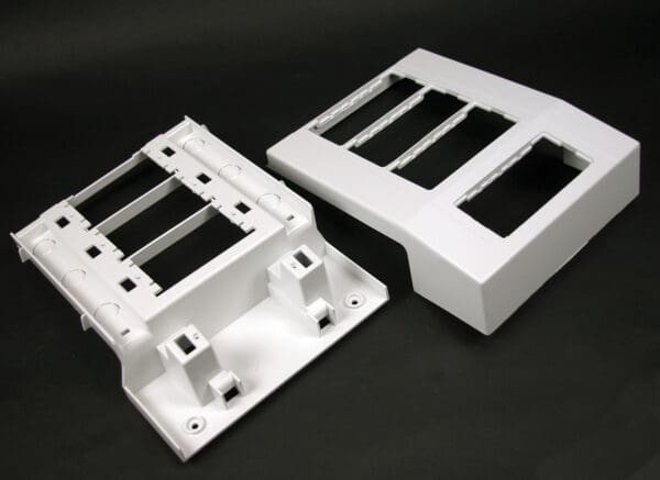 Two white plastic enclosure parts.