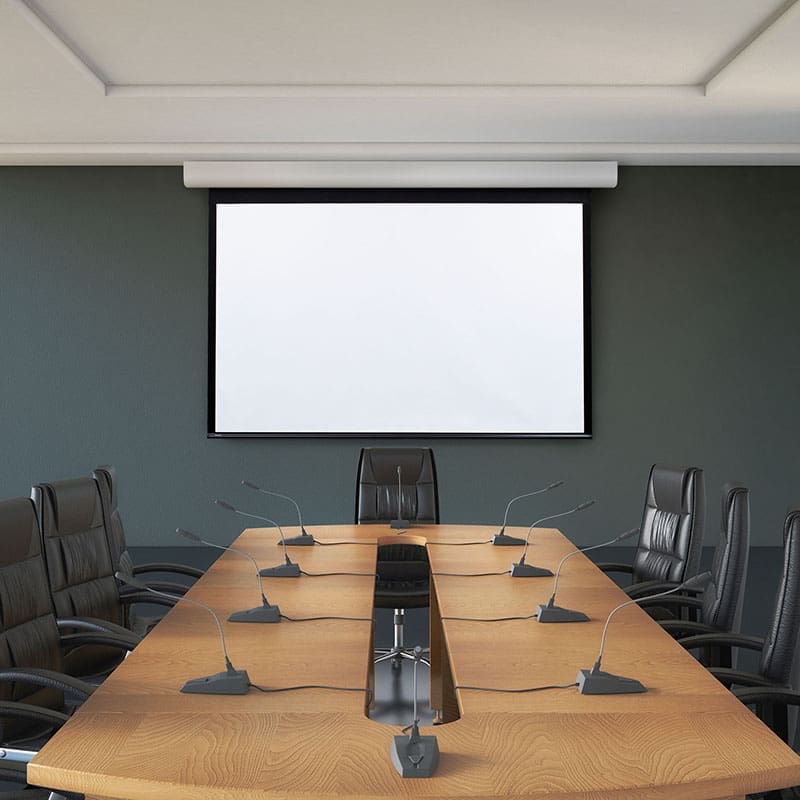 Conference room with projector and microphones.