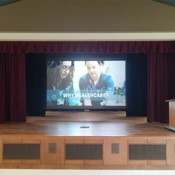 Healthcare presentation on stage screen.